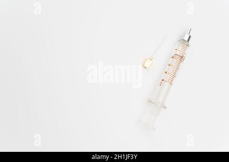 isolated sterilized glass injection syringe on a white surface Stock Photo