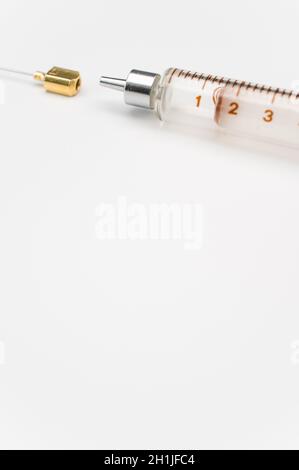 isolated sterilized glass injection syringe on a white surface Stock Photo