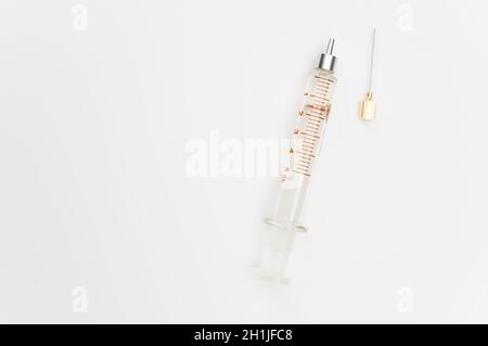 isolated sterilized glass injection syringe on a white surface Stock Photo