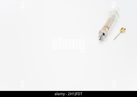 isolated sterilized glass injection syringe on a white surface Stock Photo