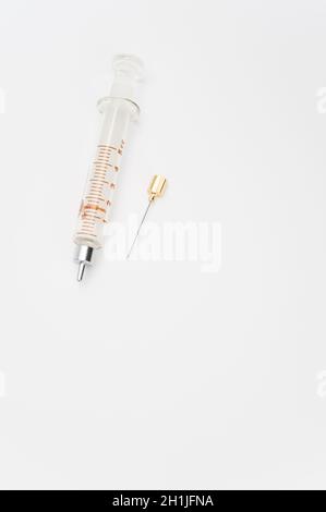 isolated sterilized glass injection syringe on a white surface Stock Photo