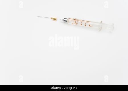 isolated sterilized glass injection syringe on a white surface Stock Photo