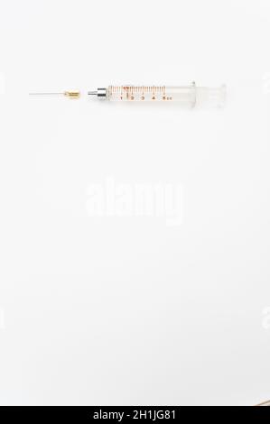 isolated sterilized glass injection syringe on a white surface Stock Photo