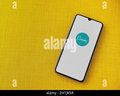 Lod, Israel - July 8, 2020: Canva - Graphic Design app play store page on the display of a black mobile smartphone on a yellow fabric background. Top Stock Photo