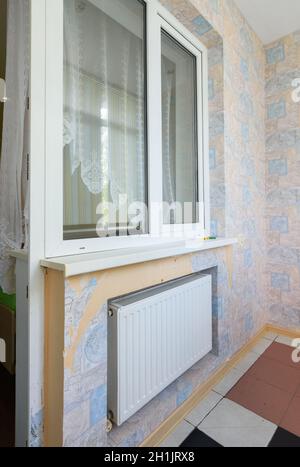 Anapa, Russia - March 3, 2020: Window opening to the balcony glazed with plastic windows, a battery is located under the window Stock Photo