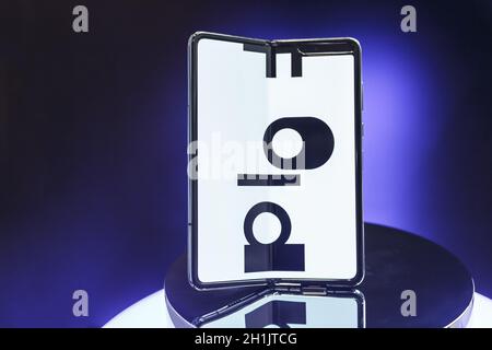 Minsk, Belarus - December 25, 2019: Viewing the new Samsung Galaxy Fold 5G. Folding touch screen smartphone on presentation stand in the showcase of t Stock Photo