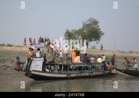Wooden boat crosses the Ganges River in Sundarbans, West Bengal, India ...