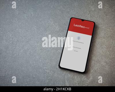 Lod, Israel - July 8, 2020: LastPass Password Manager app launch screen with logo on the display of a black mobile smartphone on ceramic stone backgro Stock Photo