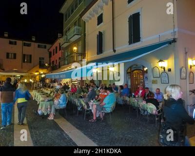 Bardolino, Italy - September 19, 2014: People are having their lunch in a cafe o in Bardolino, Garda lake Lago di Garda is a popular holiday location Stock Photo