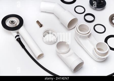 Details plastic siphon kit for bathtub on a white background. Plumbing knolling on white background. Stock Photo