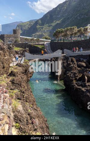 Porto Moniz, Madeira, Portugal - April 18, 2018: Natural rock pool of Porto Moniz on Madeira Island. Portugal.  It is a public bath with water from th Stock Photo