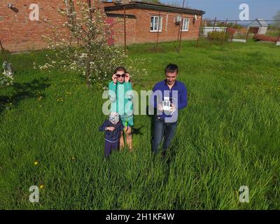 A man and a woman are photographed from a drone on a green clearing Stock Photo