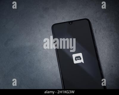 Lod, Israel - July 8, 2020: Discord app launch screen with logo on the display of a black mobile smartphone on dark marble stone background. Top view Stock Photo