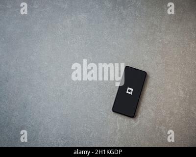 Lod, Israel - July 8, 2020: Discord app launch screen with logo on the display of a black mobile smartphone on ceramic stone background. Top view flat Stock Photo