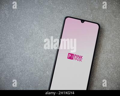 Lod, Israel - July 8, 2020: Pink Park app launch screen with logo on the display of a black mobile smartphone on ceramic stone background. Top view fl Stock Photo
