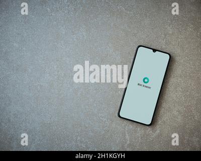 Lod, Israel - July 8, 2020: Mint Browser app launch screen with logo on the display of a black mobile smartphone on ceramic stone background. Top view Stock Photo