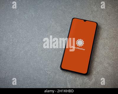 Lod, Israel - July 8, 2020: AccuWeather app launch screen with logo on the display of a black mobile smartphone on ceramic stone background. Top view Stock Photo