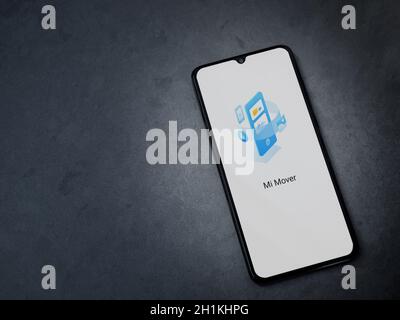 Lod, Israel - July 8, 2020: Mi Mover app launch screen with logo on the display of a black mobile smartphone on dark marble stone background. Top view Stock Photo
