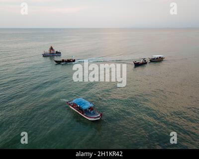 Teluk Bahang, Penang/Malaysia - Mar 08 2020: Floating chariot and fishing boat at sea. Stock Photo