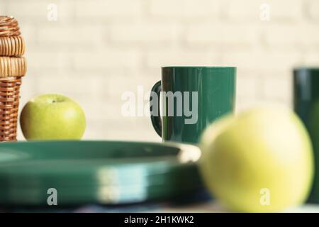 Green plastic kitchenware on a table close up Stock Photo
