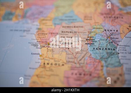 Close up picture focused on Kinshasa, capital of the Democratic Republic of the Congo with its main routes in red, and on a colorful map of Africa wit Stock Photo