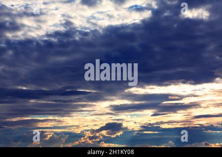 Crepuscular rays burst through the dark clouds Stock Photo