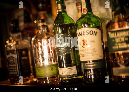 Bucharest, Romania - July 14, 2020: Illustrative editorial image of various whisky bottles displayed in a pub in Bucharest, Romania.