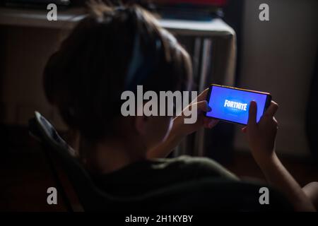 Bucarest, Romania - June 25. 20202: Image a child playing Fortnite, a game by Epic Games, on a mobile phone in Bucharest, Romania. Stock Photo