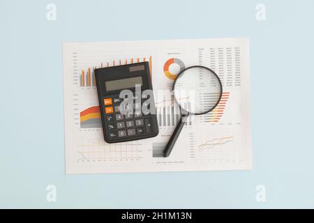 Business graphs, charts and magnifying glass on table. Financial development, Banking Account, Statistics Stock Photo