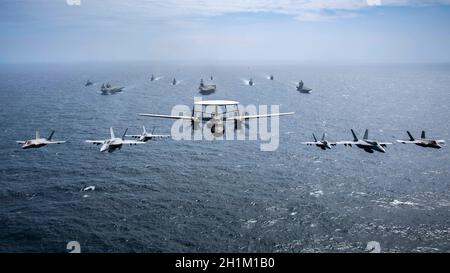 Bay of Bengal, India. 17th Oct, 2021. Multi-national aircraft lead a formation of the U.S. Navy Nimitz-class aircraft carrier USS Carl Vinson, center, Royal Navy Fleet Flagship HMS Queen Elizabeth, left, and Japan Maritime Self- Defense Force Izumo-class helicopter destroyer JS Kaga, right, during exercises October 17, 2021 in the Bay of Bengal, India. Credit: MC2 Haydn Smith/U.S. Navy/Alamy Live News Stock Photo