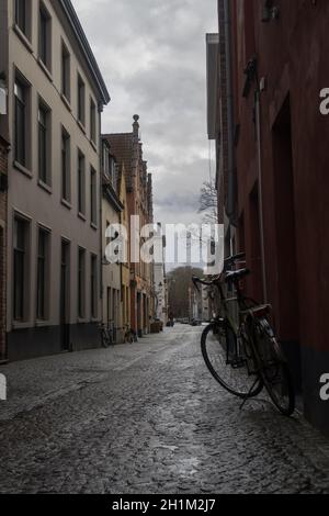 Bike on the streets of Bruges. Bike with buildings and cloudy day. Old bike on the streets Stock Photo