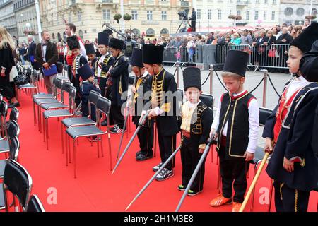 Parade of 70 participants, thirty horses and forty members of a brass band to the main square were announced next, 300th Sinjska Alka in Zagreb Stock Photo