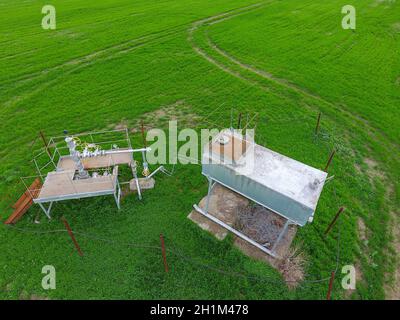 A tank with methanol near the oil well. Equipment of an oil well. Shutoff valves and service equipment. Stock Photo