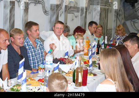 Festive table with delicious dishes. Many food on table for family holiday. Guests gathered together at festive table. Relatives have lunch at festive Stock Photo