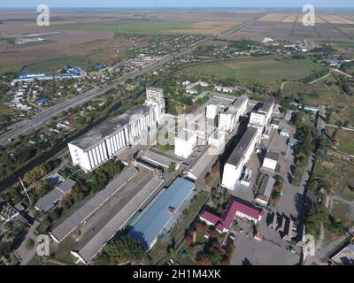 Top view of a silo elevator. The huge building for storing and drying grain. Aerophotographing industrial object. Stock Photo