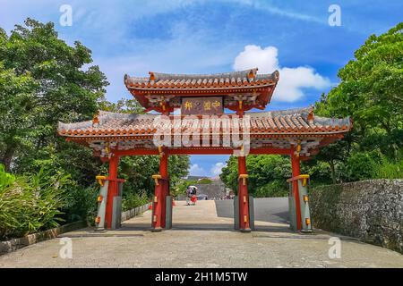 Shureimon Gate in Shuri castle in Okinawa, Japan with blue sky. The wooden tablet that adorns the gate features Chinese characters that mean “Land of Stock Photo