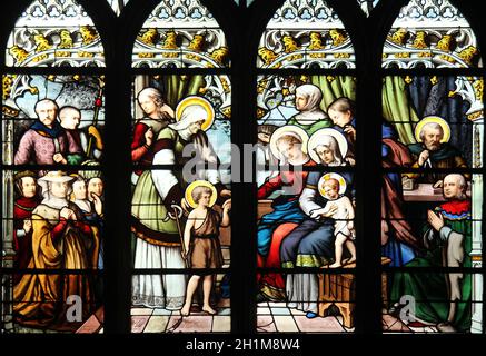 St. John the Baptist introduced by his mother, St. Elizabeth, the Infant Jesus and the Holy Kinship (The Virgin, St. Joseph and St. Anne), stained gla Stock Photo