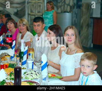Festive table with delicious dishes. Many food on table for family holiday. Guests gathered together at festive table. Relatives have lunch at festive Stock Photo