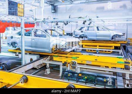 Assembling cars on conveyor line in car plant Stock Photo