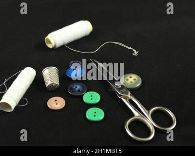 Sewing Needle thread scissors thimble tailor buttons Stock Photo