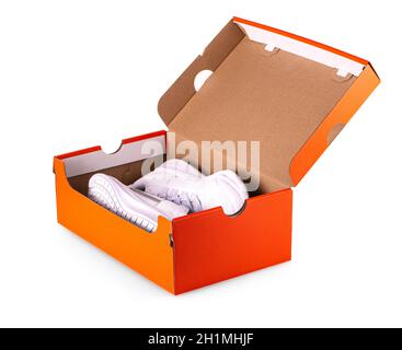 New white sneakers shoes in red box. Taken at studio and isolated over white background Stock Photo