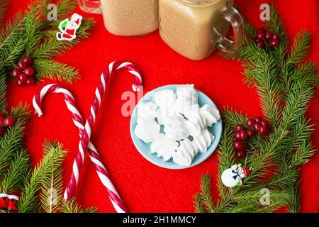 Christmas tree, candy, coffee marshmellou on a red background. Happy New Year. Stock Photo