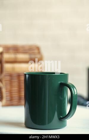 Green plastic kitchenware on a table close up Stock Photo