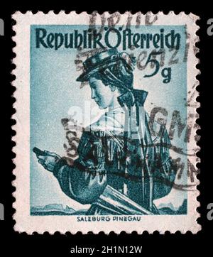 Stamp printed in the Austria shows Woman from Salzburg, Pinzgau, Regional Costume, circa 1949 Stock Photo