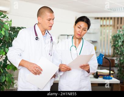 Two doctors discussing about medical report Stock Photo