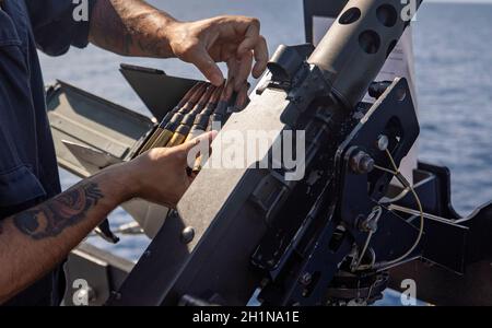 211016-N-KY668-1442   CARIBBEAN SEA - (Oct. 16, 2021) – Gunner’s Mate 2nd Class Manuel Iduate loads a .50-caliber machine gun aboard the Freedom-variant littoral combat ship USS Billings (LCS 15) during the live-fire phase of a bilateral maritime exercise with the Jamaica Defence Force, Oct. 16, 2021. Billings is deployed to the U.S. 4th Fleet area of operations to support Joint Interagency Task Force South’s mission, which includes counter-illicit drug trafficking missions in the Caribbean and Eastern Pacific. (U.S. Navy photo by Mass Communication Specialist 2nd Class Austin G. Collins/Relea Stock Photo