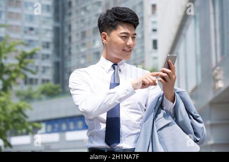 Confident businessman staring at his phone Stock Photo
