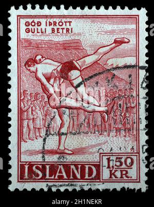 Stamp issued in Iceland shows wrestling, sports serie, circa 1957. Stock Photo