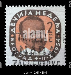 Stamp issued in Yugoslavia shows Head of an infant, Children's Week, circa 1954. Stock Photo