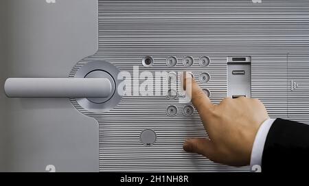 Opening the code lock on the door with the touch of your fingers. Stock Photo